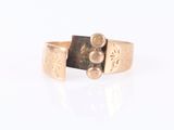 a close up of a gold ring with a black stone on it