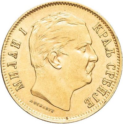 a close up of a gold coin with a man ' s face on it