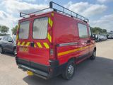 a red van that is parked in a parking lot