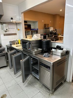 a large kitchen with stainless steel counter tops and appliances