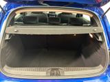 the back of a blue car with its trunk open