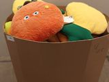 a box full of stuffed fruits and vegetables on the floor