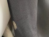 a close up of a mannequin wearing a black coat and a white shirt