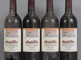 three bottles of wine are lined up on a table