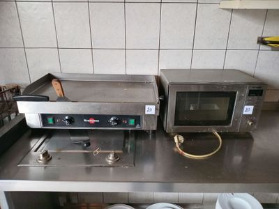 two microwaves sitting on a counter in a kitchen