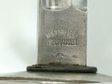 a close up of a metal object on a white surface