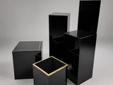 a group of four black boxes with gold trims on them