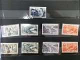 many different stamps on display in a glass case