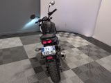 a motorcycle that is parked in a room with a checkered floor