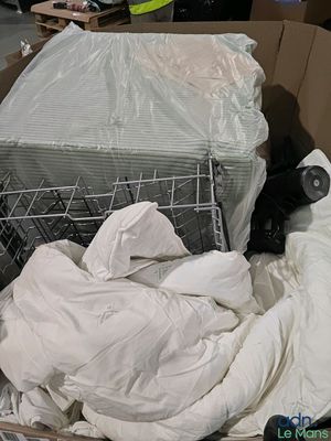 a cat that is sitting in a box with a lot of stuff