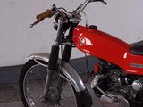 a red motorcycle that is parked in a garage