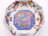 a bowl with a design on it on a white surface