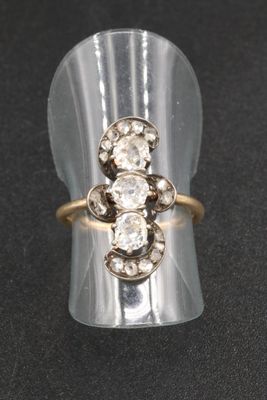 a close up of a ring with three diamonds on it