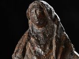 statue of a woman with a veil on her head on a black background