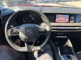 someone is sitting in the driver ' s seat of a car with their feet on the steering wheel