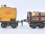 two toy trains that are sitting side by side in the snow