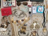 many different types of necklaces and bracelets laid out on a table