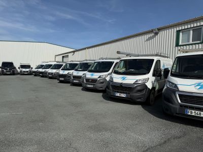 many vans parked in a row outside of a building