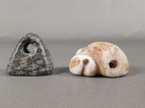 two small stones sitting next to each other on a table
