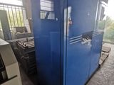 a blue refrigerator sitting in a room with a lot of boxes