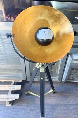 an image of a large gold disc on a tripod