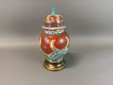 an image of a red and blue vase sitting on top of a table