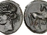 a silver coin with a horse and a woman on it