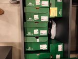 many green boxes stacked on top of each other in a room