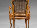 a wooden chair with a cane back and a cane seat