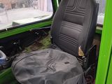 a seat in the back of a green vehicle