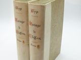 two books sitting on top of each other on a white surface