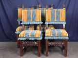 four chairs with yellow and blue striped upholstered cushions