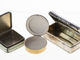 three tins that are sitting next to each other