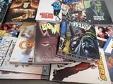 a lot of comic books sitting on a table