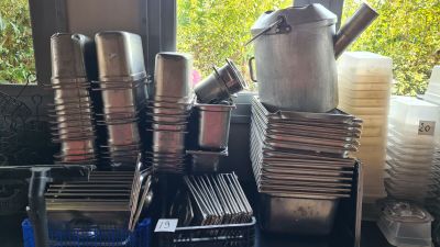 many pots and pans stacked on a table