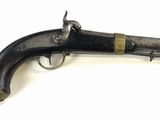an old gun that is on display on a white surface