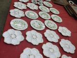 many plates on a table with a red table cloth