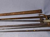 four old metal tools are sitting on a blue cloth