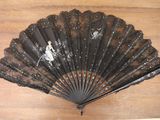 a black fan with a picture of a skeleton on it
