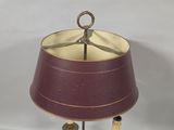 a lamp that is on a stand with a lamp shade on top of it