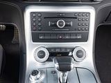 the interior of a car with a dash panel and a steering control