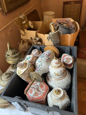 a box full of antique vases on a table