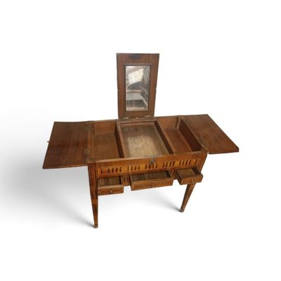 a small wooden table with a mirror on top of it