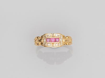 a gold ring with pink stones and diamonds