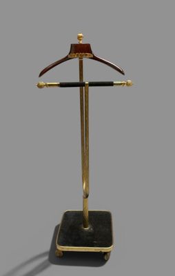 un porte-manteau doré et noir sur lequel est accroché un cintre en bois