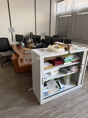 a desk with a bookcase and a computer monitor on it