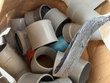 a cardboard box filled with many different types of pipes