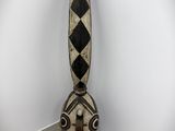 a large wooden sculpture with a black and white design on it