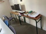 a desk with a computer on it in a room