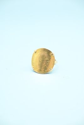 an image of a gold ring on a white surface